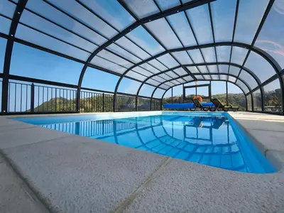 an indoor swimming pool with a retractable roof at Casa Leão de Ouro by LovelyStay in São Jorge