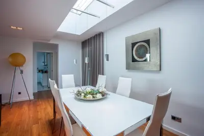 a dining room with a white table and chairs at Casa Martinhos by LovelyStay in Caniço