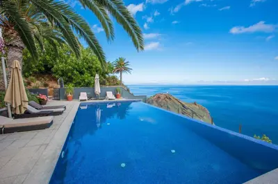a swimming pool with a view of the ocean at Casa Martinhos by LovelyStay in Caniço