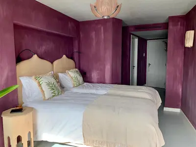 a bedroom with blue walls and a bed and a chair at Okulus Madeira in Funchal