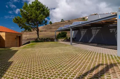 a house with a solarium next to a mountain at Villa Flora - Nature & Tranquility - Heated pool optional in Jardim do Mar