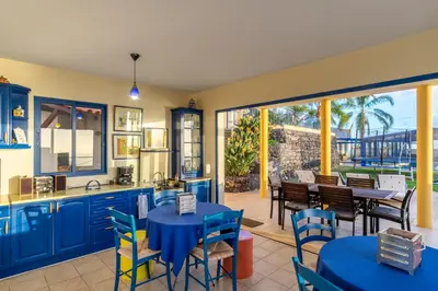 a kitchen and dining room with blue tables and chairs at Relax View in Funchal