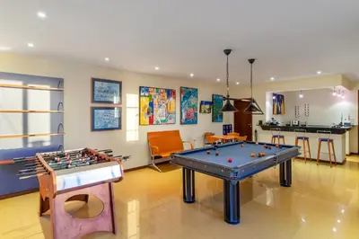 a room with two pool tables and a bar at Relax View in Funchal
