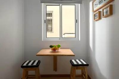 a table with a bowl of fruit on it in front of a window at Ribeira das Casas by Homie in Funchal
