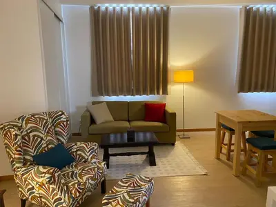 a living room with a couch and a chair at Ribeira das Casas by Homie in Funchal
