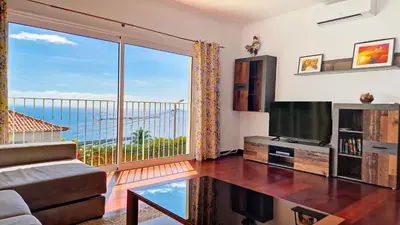 a living room with a large window with a view at Casa Eleanor by LovelyStay in Calheta