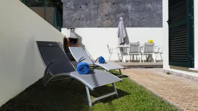 two chairs sitting on the grass on a patio at Casa Eleanor by LovelyStay in Calheta