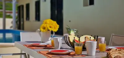 a table with plates of food and glasses of orange juice at Casa Eleanor by LovelyStay in Calheta