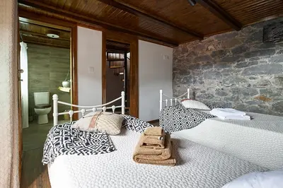 two beds in a room with a bathroom at Ga281 in Funchal
