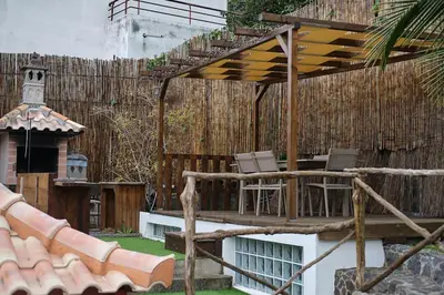 a patio with chairs and a wooden pergola at Ga281 in Funchal