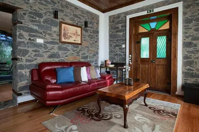 a living room with a red leather couch and a table at Ga281 in Funchal
