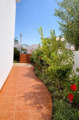 a walkway in a garden with flowers and plants at Casadaluz 18 in Luz