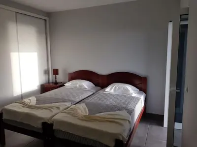 a bedroom with two twin beds in a room at O pomar - A quiet SUNNY place with amazing SEA views in Paul do Mar