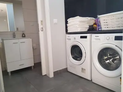 a laundry room with a washing machine and a washer at O pomar - A quiet SUNNY place with amazing SEA views in Paul do Mar
