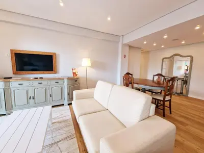 a living room with a white couch and a table at Princesa Madeira in Funchal