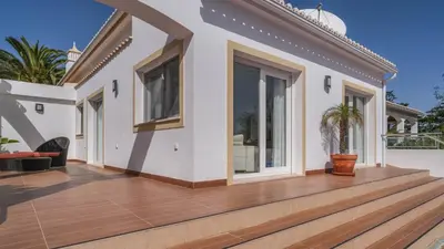 a house with a large wooden deck at Casa Monte Cristo Too in Lagos