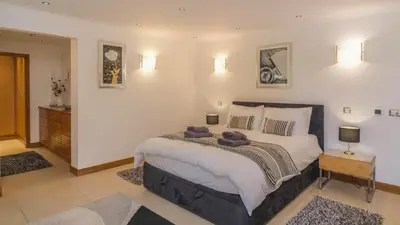 a bedroom with a large bed with two teddy bears on it at Casa Monte Cristo Too in Lagos