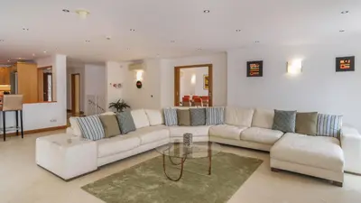 a living room with a white couch and a glass table at Casa Monte Cristo Too in Lagos