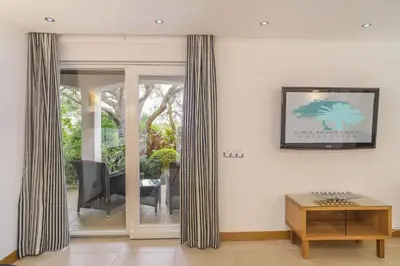 a living room with curtains and a table at Casa Monte Cristo Too in Lagos