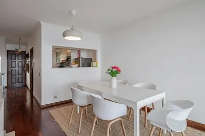 a dining room with a white table and white chairs at Casa Skyline by An Island Apart in Caniço