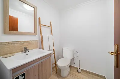 a bathroom with a toilet and a sink at Casa Skyline by An Island Apart in Caniço
