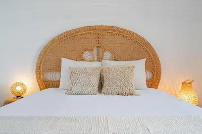 a bedroom with a large white bed with pillows at Casa Skyline by An Island Apart in Caniço
