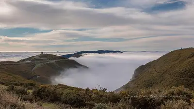 a view of a mountain with clouds in the valley at Martinho Apartment View in Arco da Calheta