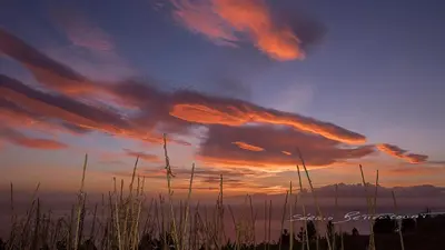 a sunset with clouds in the sky over a body of water at Martinho Apartment View in Arco da Calheta