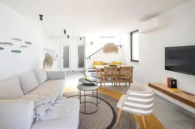 a living room with a couch and a table at Casas da Praia by Sevencollection in Salema