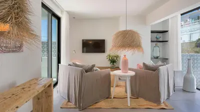 a living room with two chairs and a table at Casas da Praia by Sevencollection in Salema
