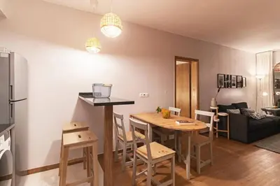 a kitchen and living room with a table and chairs at Ocean View in Ponta Delgada