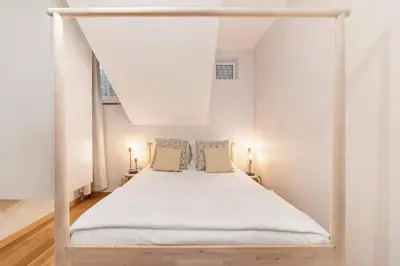 a bedroom with a white bed with two pillows at Ocean View in Ponta Delgada