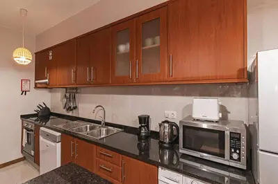a kitchen with a sink and a microwave at Ocean View in Ponta Delgada