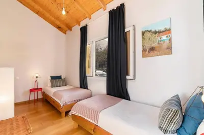 a bedroom with two beds and a window at Ocean View in Ponta Delgada
