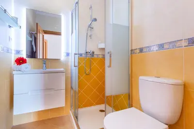 a bathroom with a toilet and a shower at Lovely 2 bedroom apartment including pool, stunning ocean views & beach closeby in Luz
