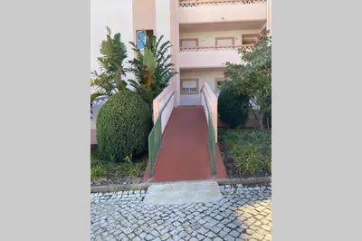 a house with a red walkway in front of it at Lovely 2 bedroom apartment including pool, stunning ocean views & beach closeby in Luz