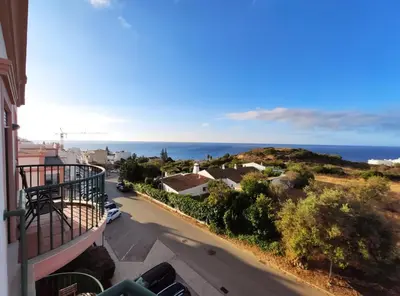 a view of the ocean from the balcony of a house at Lovely 2 bedroom apartment including pool, stunning ocean views & beach closeby in Luz