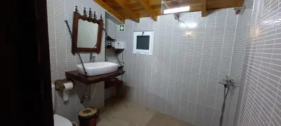 a bathroom with a sink and a mirror and white tiles at Casa da Bisa - Santa Maria - Açores in Santa Bárbara