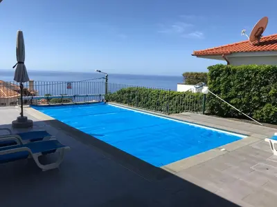 a kitchen with a counter with a bowl of oranges on it at Blue Villa in Arco da Calheta