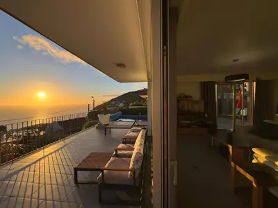 a swimming pool with the ocean in the background at Blue Villa in Arco da Calheta