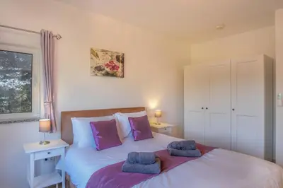 a bedroom with a bed with two towels on it at Casa Monte Cristo IV in Lagos