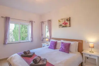 a bedroom with a large bed with towels on it at Casa Monte Cristo IV in Lagos