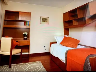 a bedroom with a desk and a bed and a desk and chair at Charming Lido Flat I in Funchal