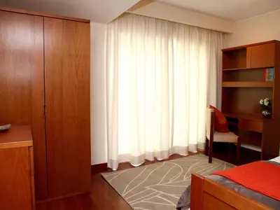 a bedroom with a bed and a large window at Charming Lido Flat I in Funchal