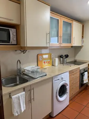 a kitchen with a sink and a washing machine at Charming Lido Flat I in Funchal