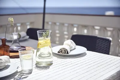 a table with a glass of water and a plate at Casas Sul in Burgau