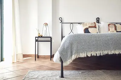 a bedroom with a bed and a side table at Casas Sul in Burgau