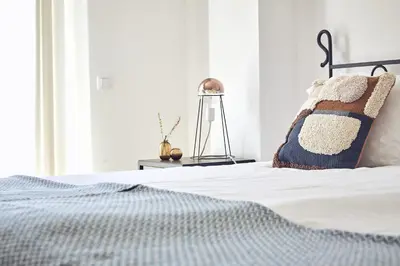 a bedroom with a bed and a lamp at Casas Sul in Burgau