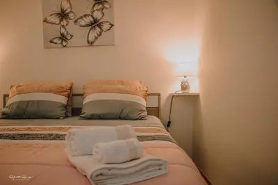 a bedroom with two beds with towels on them at Green Valley House Madeira in Ribeira Brava