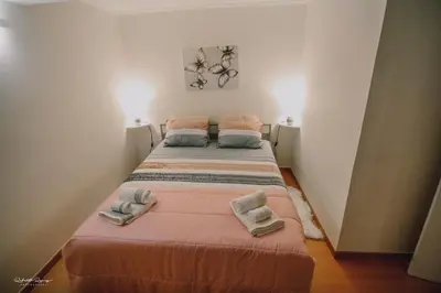 a bed in a room with two towels on it at Green Valley House Madeira in Ribeira Brava